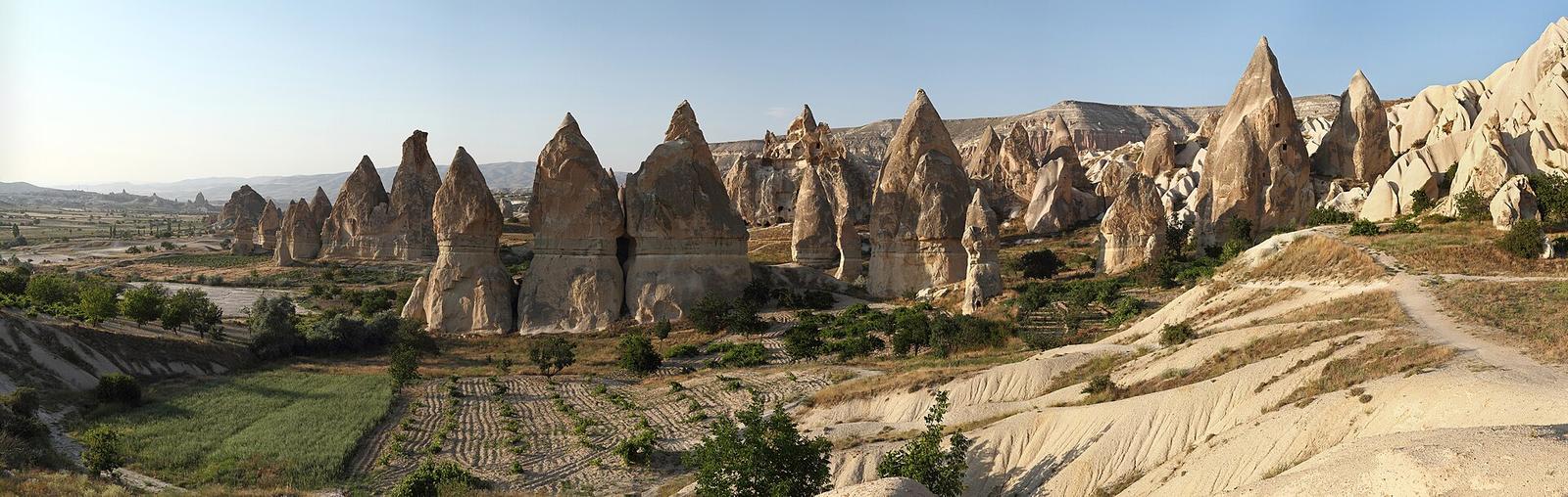 Fairy chimney rock formations rising from the Cappadocia valley floor at golden hour