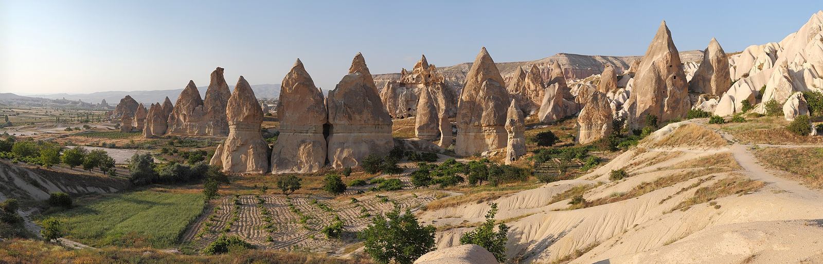 Hot air balloons floating above the fairy chimneys of Cappadocia at sunrise