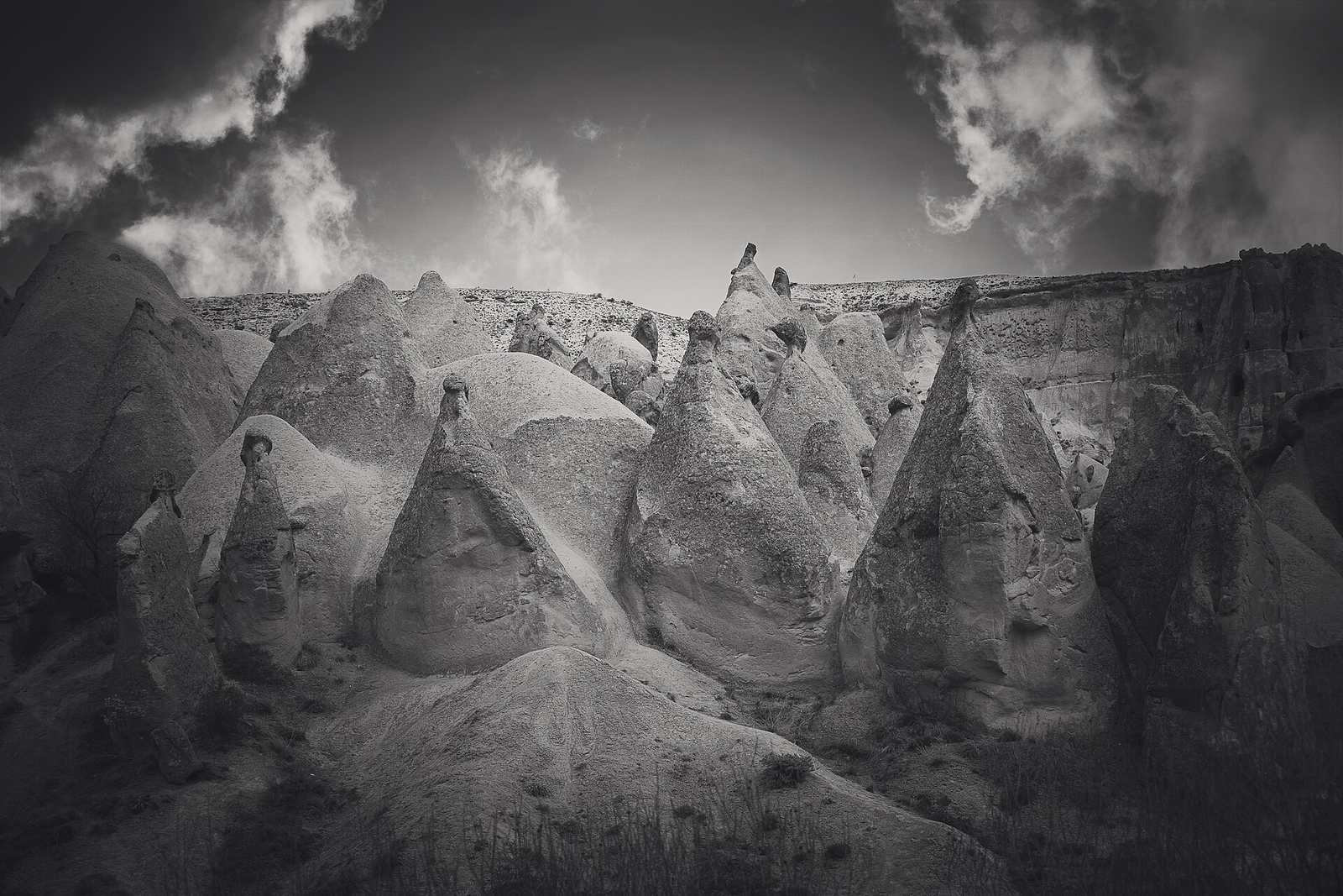 Cave dwellings and rock-cut dovecotes carved into a cliff face near Uçhisar, Cappadocia