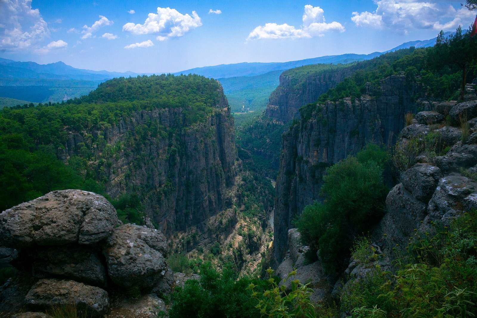 Rafters resting in calmer water beneath the canyon walls of Köprülü Canyon