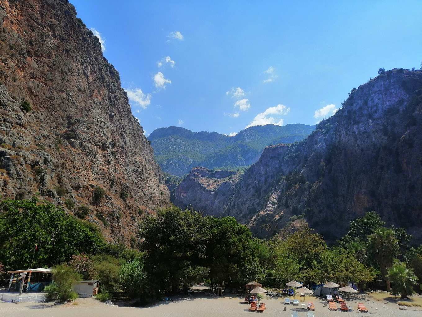 A hiker's boots and trekking poles on the rocky Lycian Way trail