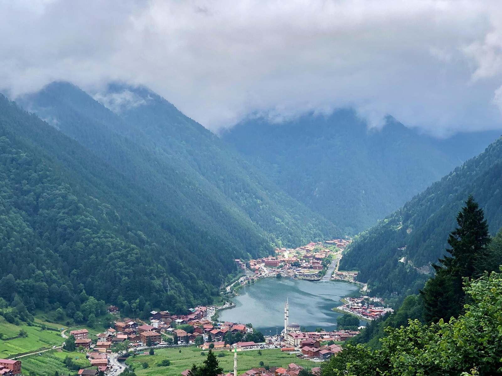 Group of visitors walking the lakeside boardwalk at Uzungöl